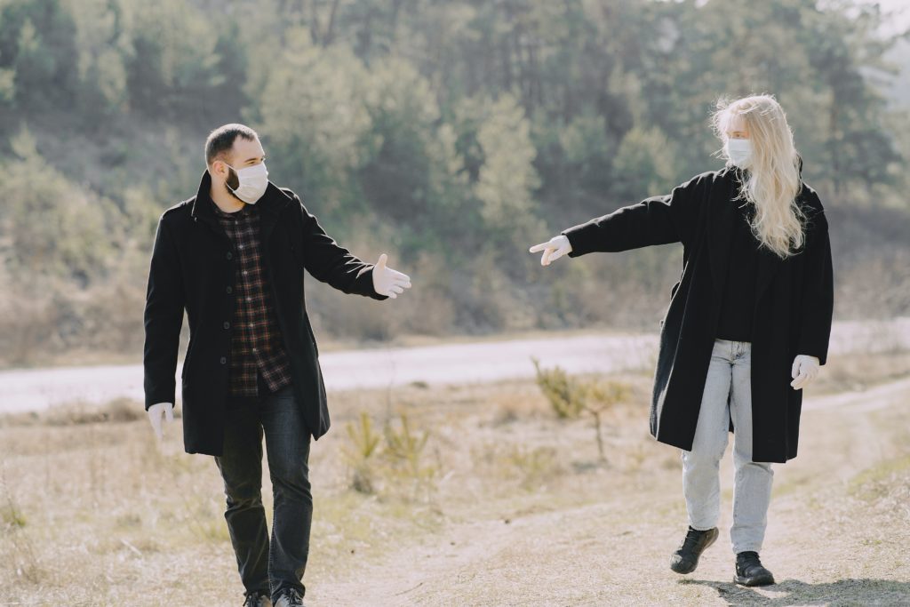 friends in medical gloves and masks walking along road in 4127590